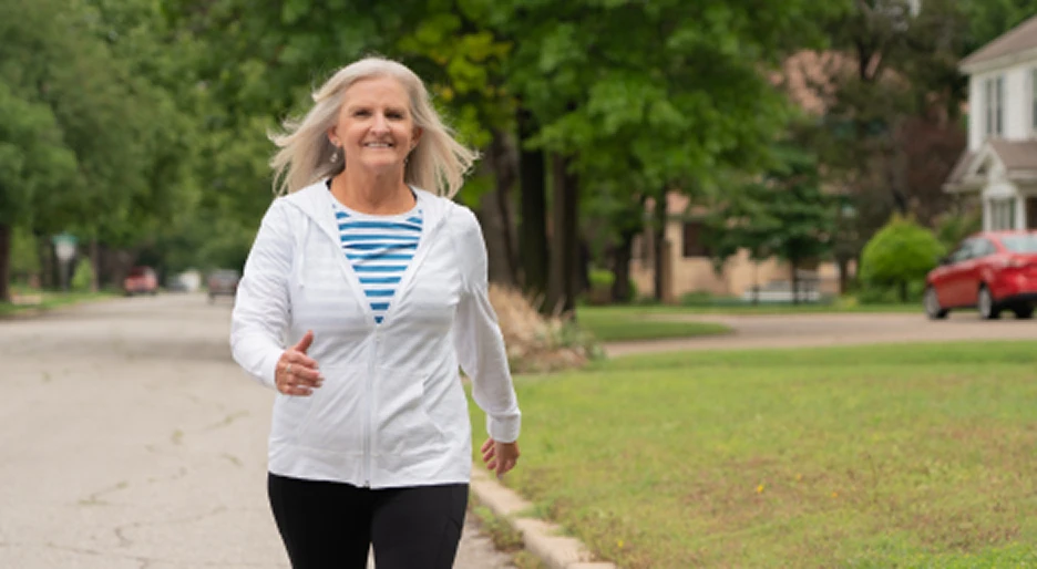 Older woman walking briskly along a neighborhood street