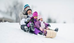 Family sledding in snow