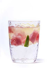 Watermelon, jalapeño and lemon slices in textured water glass
