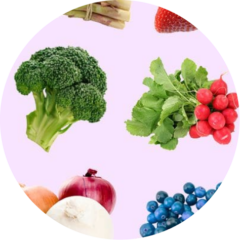 Fresh produce on a light background: broccoli, radishes, onions, asparagus, strawberries and blueberries.